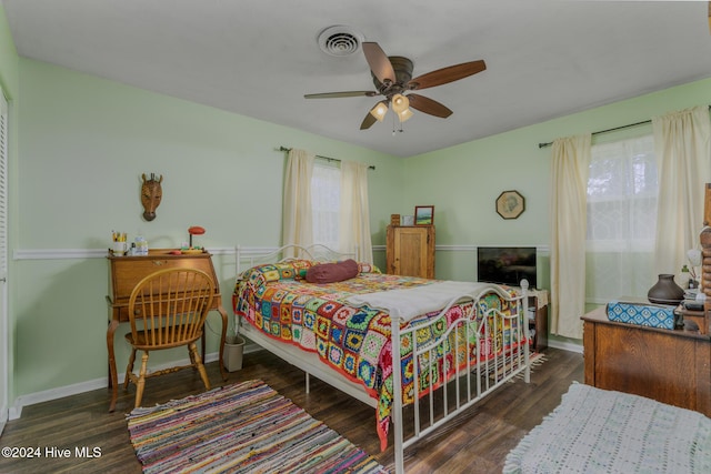 bedroom with ceiling fan and dark wood-type flooring