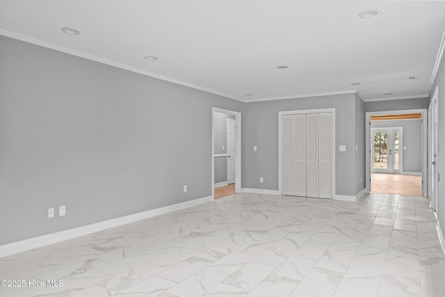 unfurnished bedroom featuring french doors, a closet, and crown molding