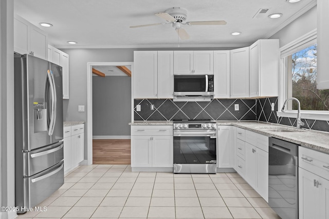 kitchen featuring white cabinetry, stainless steel appliances, and light tile patterned floors