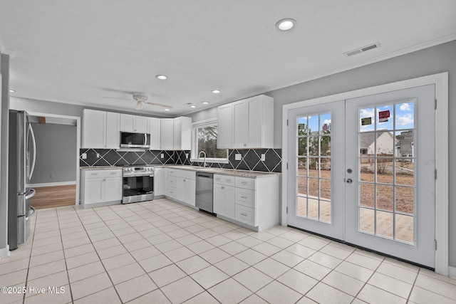 kitchen featuring white cabinets, ceiling fan, appliances with stainless steel finishes, and french doors