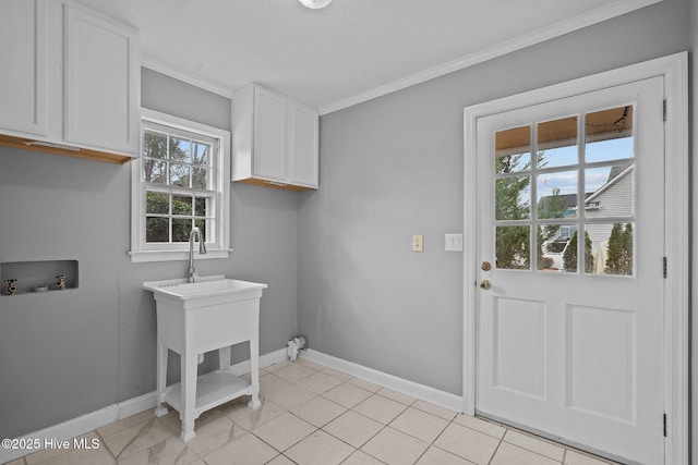 clothes washing area with cabinets, washer hookup, light tile patterned floors, and ornamental molding