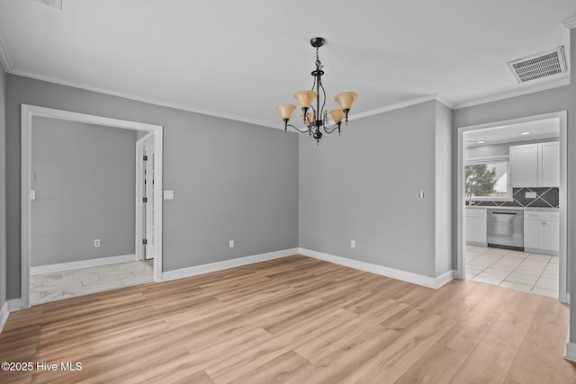 unfurnished dining area with light hardwood / wood-style flooring, ornamental molding, and an inviting chandelier