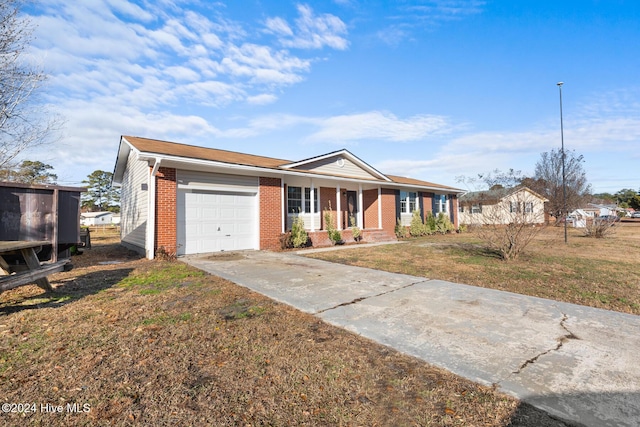 ranch-style home featuring a front lawn and a garage