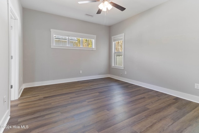 spare room featuring ceiling fan and dark wood-type flooring