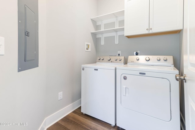 clothes washing area featuring dark hardwood / wood-style floors, cabinets, electric panel, and washing machine and clothes dryer