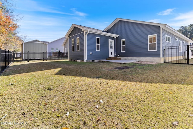 back of house with a lawn