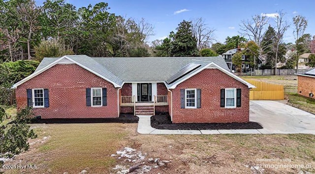 single story home with brick siding, a front yard, and fence