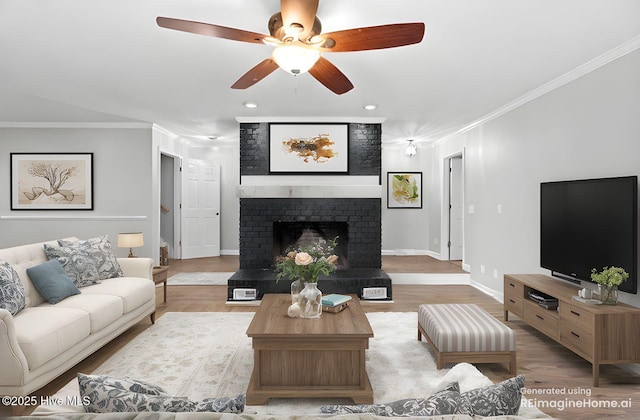 living room with wood finished floors, baseboards, a fireplace, ceiling fan, and ornamental molding