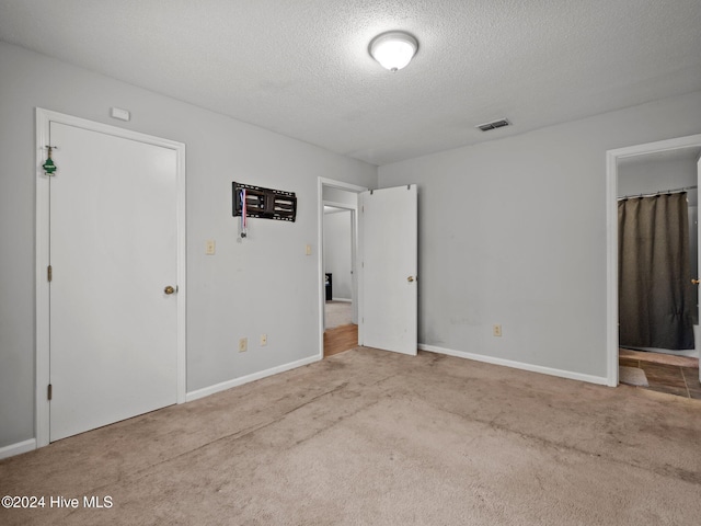 empty room featuring carpet floors and a textured ceiling