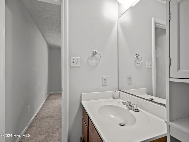 bathroom with vanity and a textured ceiling