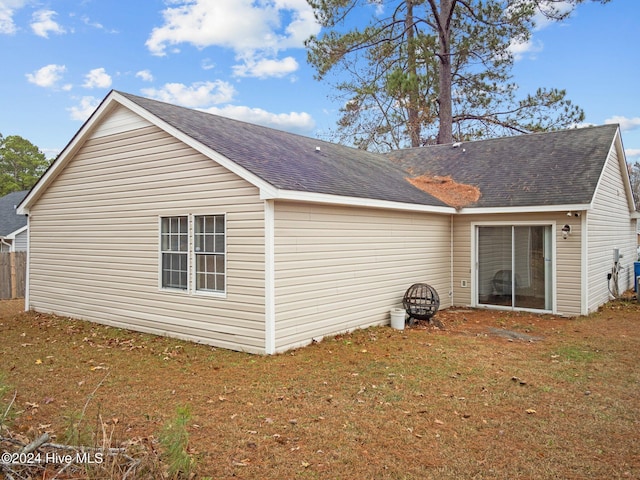 view of side of home with a lawn