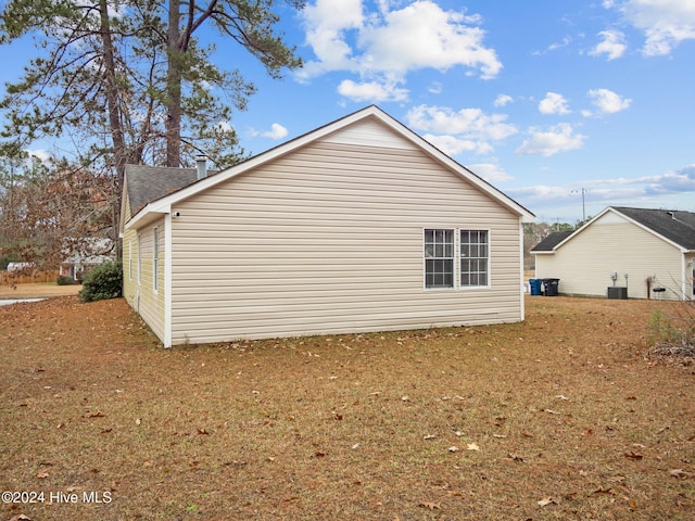 view of side of home with central AC