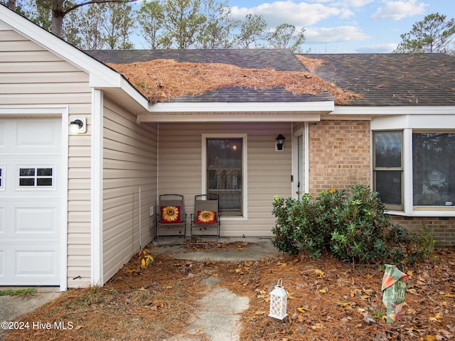 view of exterior entry featuring a garage