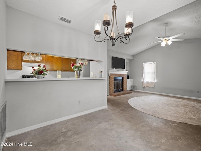 unfurnished living room with ceiling fan with notable chandelier, lofted ceiling, concrete flooring, and a brick fireplace