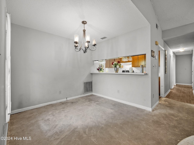 interior space with a chandelier and a textured ceiling