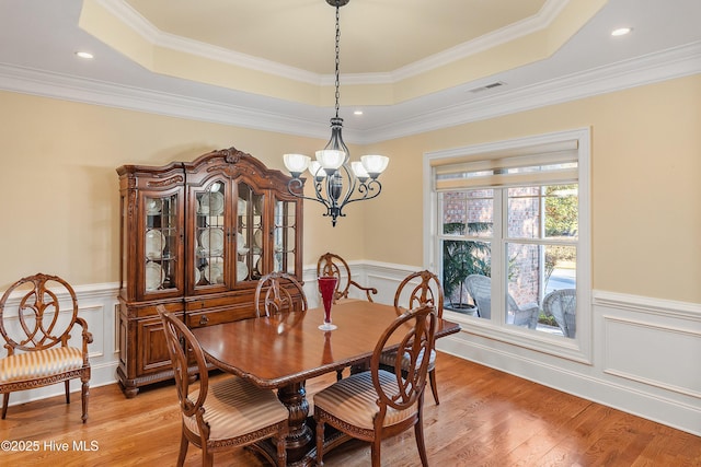 dining space featuring a tray ceiling and ornamental molding