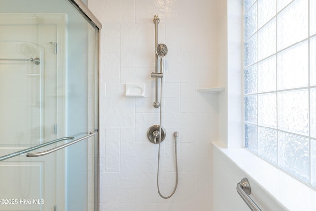 bathroom with a shower with shower door