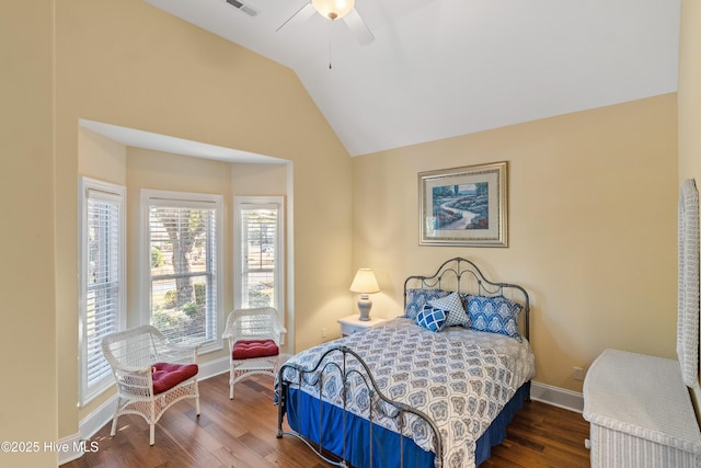 bedroom featuring ceiling fan, dark hardwood / wood-style floors, and lofted ceiling