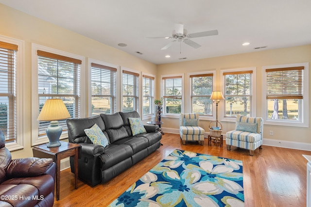 living room featuring light wood-type flooring and ceiling fan