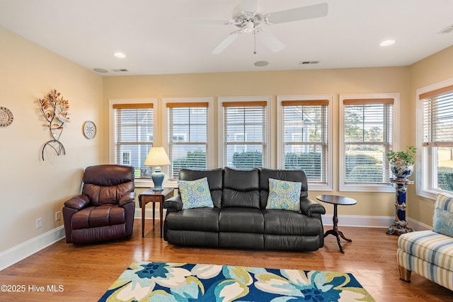 living room with ceiling fan and light hardwood / wood-style floors