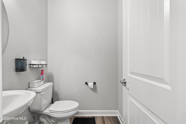 bathroom featuring wood-type flooring and toilet