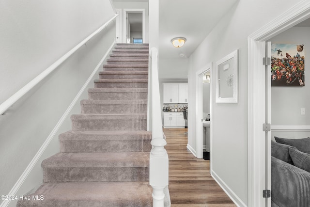 staircase featuring hardwood / wood-style flooring