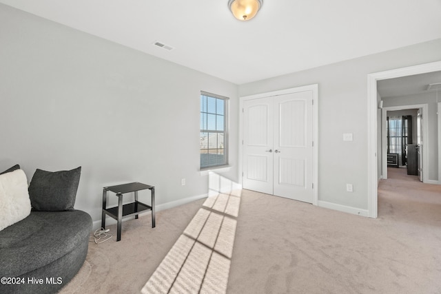 sitting room with light colored carpet