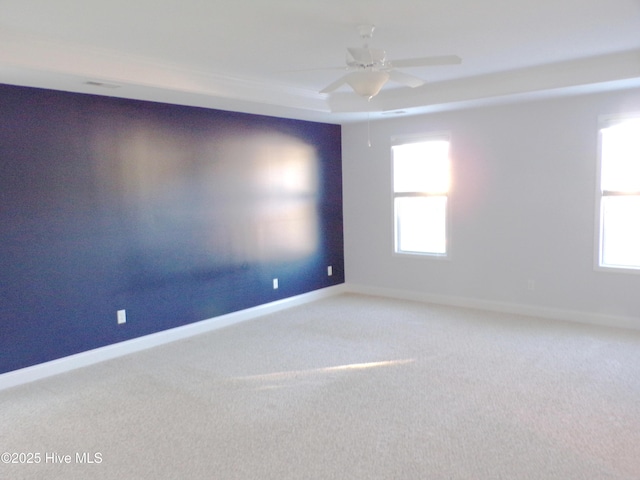 carpeted empty room featuring ceiling fan