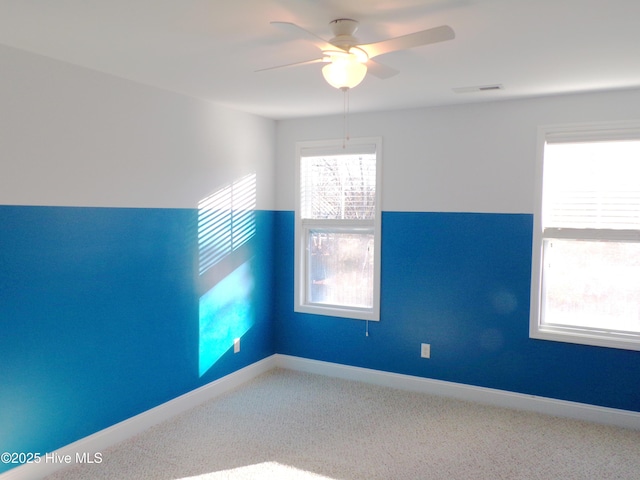 spare room featuring carpet flooring and ceiling fan