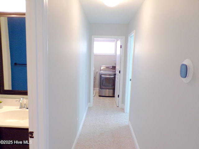 corridor with sink and washer / dryer