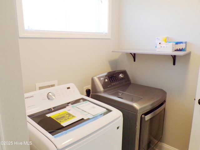 clothes washing area with washing machine and dryer