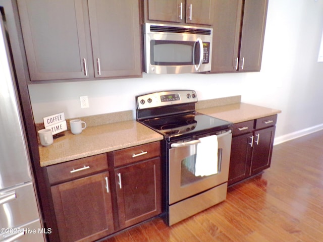 kitchen with light wood-type flooring and stainless steel appliances