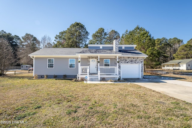 view of front of house with a garage, a front lawn, and covered porch