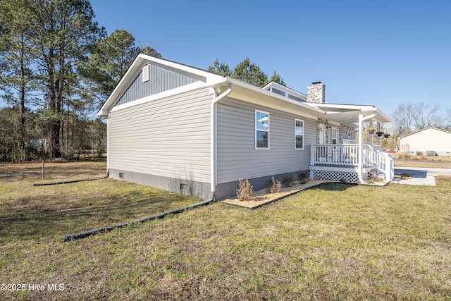 view of home's exterior featuring a porch and a yard