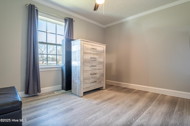 unfurnished bedroom featuring crown molding, hardwood / wood-style floors, and ceiling fan