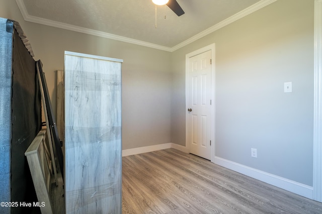 empty room featuring crown molding, a textured ceiling, ceiling fan, and light wood-type flooring