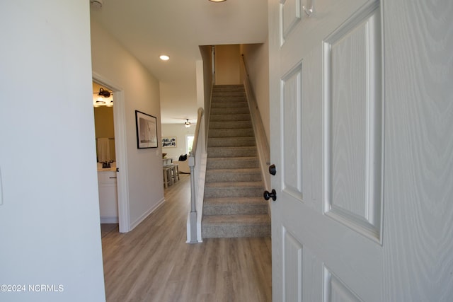 foyer entrance with light hardwood / wood-style flooring and ceiling fan