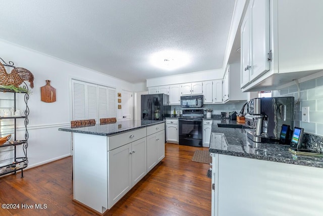 kitchen featuring a center island, backsplash, dark stone countertops, white cabinets, and black appliances