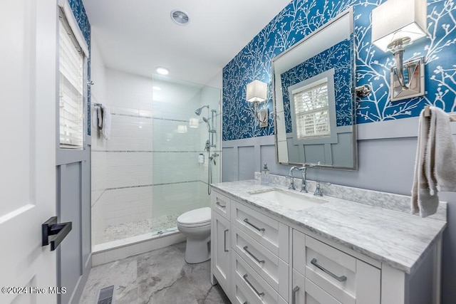 bathroom featuring vanity, an enclosed shower, and toilet