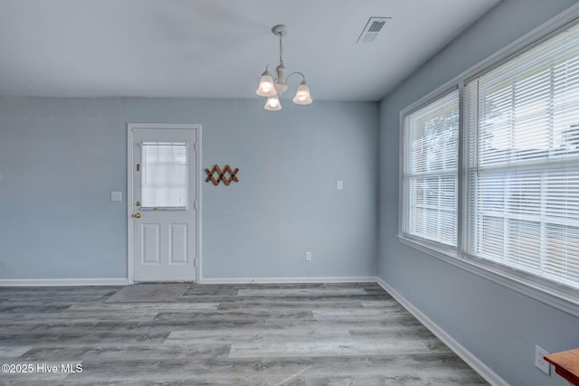 interior space featuring hardwood / wood-style floors and a notable chandelier