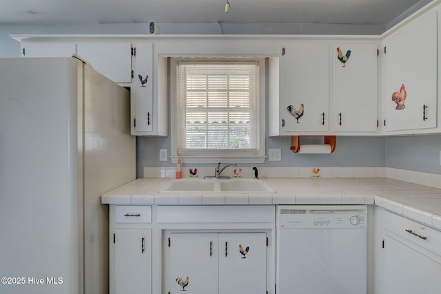 kitchen featuring white cabinets, white appliances, tile countertops, and sink