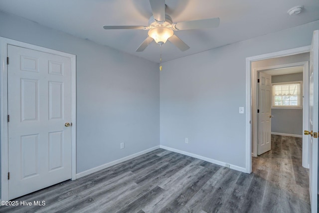 spare room with hardwood / wood-style floors and ceiling fan