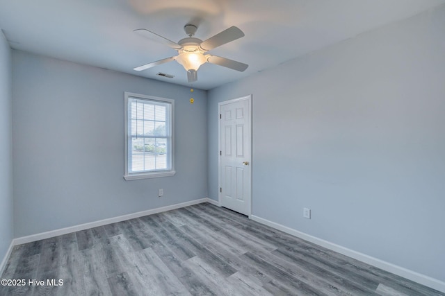 empty room with ceiling fan and light hardwood / wood-style floors