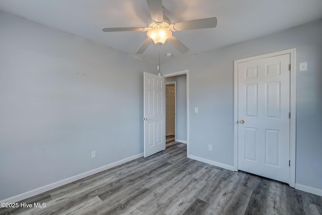 unfurnished bedroom featuring hardwood / wood-style floors and ceiling fan