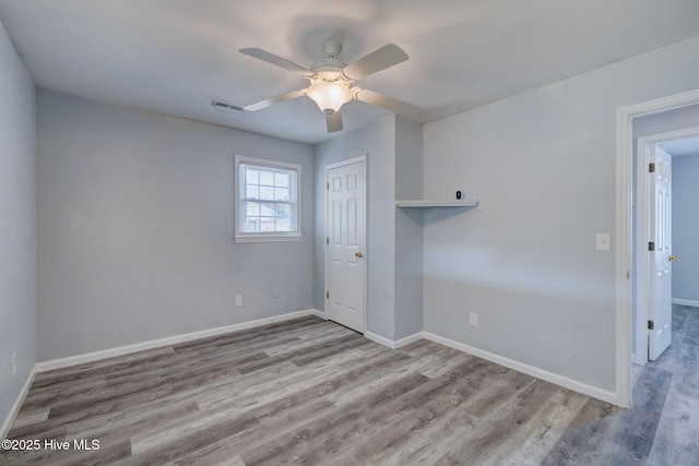 spare room with light wood-type flooring and ceiling fan