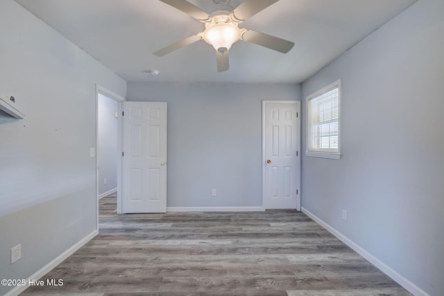 spare room with light hardwood / wood-style floors and ceiling fan