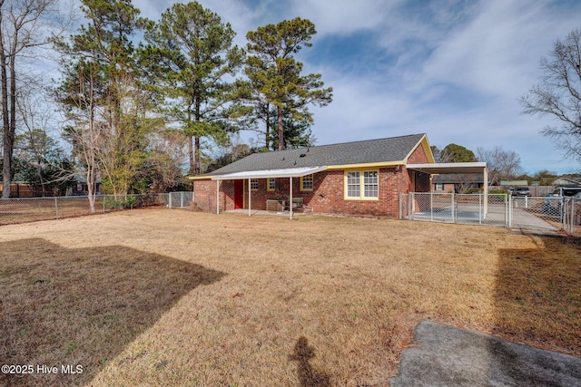 back of house with a yard and a carport