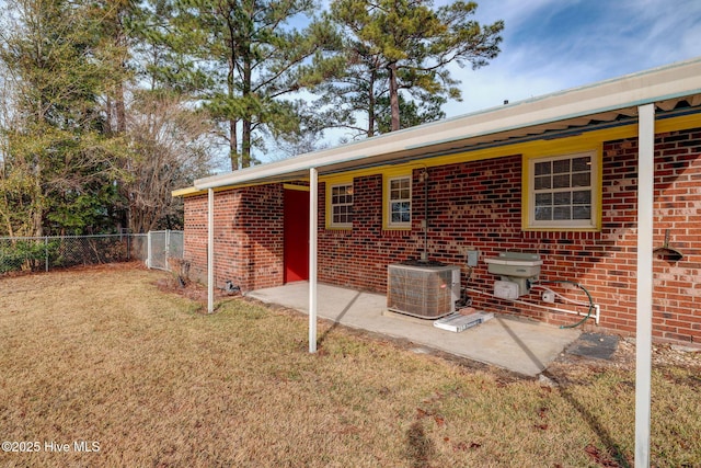 back of house featuring a patio, central AC unit, and a lawn