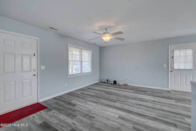 foyer entrance with ceiling fan and light wood-type flooring