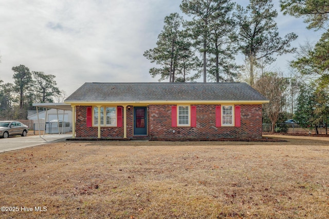 single story home with a front lawn and a carport